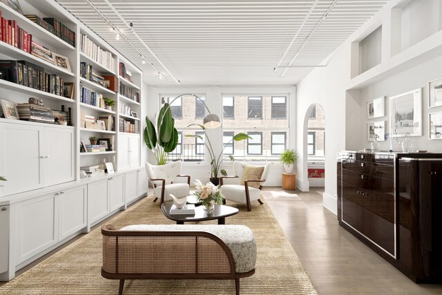 sitting room featuring rail lighting and light hardwood / wood-style floors