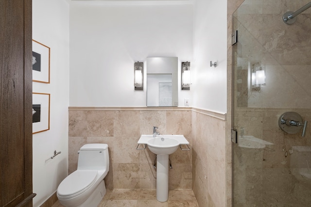 bathroom featuring toilet, tile walls, and an enclosed shower