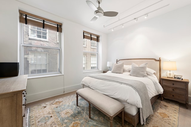 bedroom with ceiling fan and light hardwood / wood-style flooring