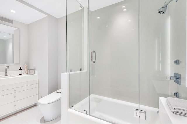 full bathroom featuring toilet, combined bath / shower with glass door, vanity, and tile patterned flooring