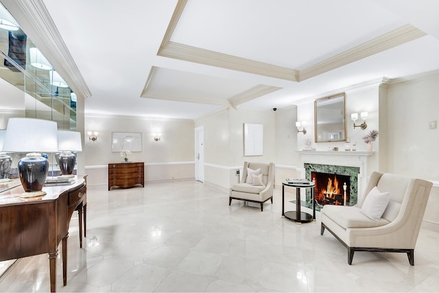 sitting room featuring a high end fireplace and ornamental molding