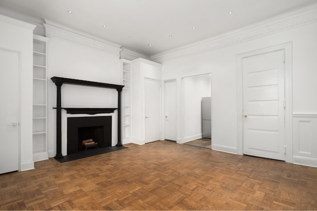 unfurnished living room featuring dark parquet flooring, crown molding, and built in features