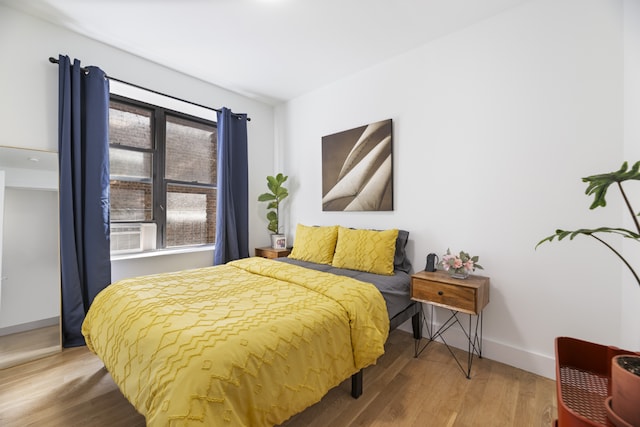 bedroom with hardwood / wood-style floors