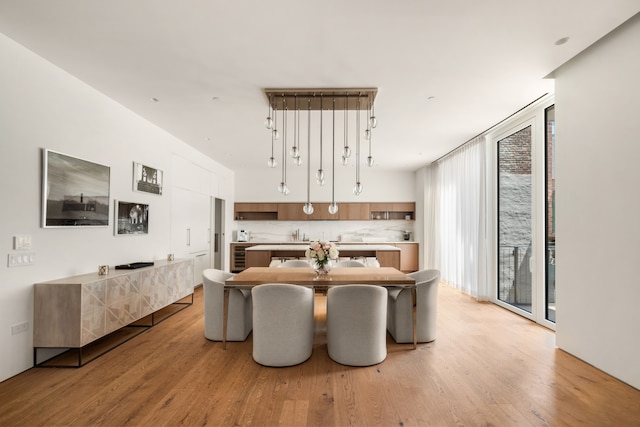 dining room featuring light hardwood / wood-style floors and wine cooler