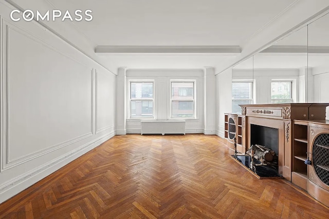 living room with ornamental molding, beam ceiling, light parquet flooring, and radiator heating unit