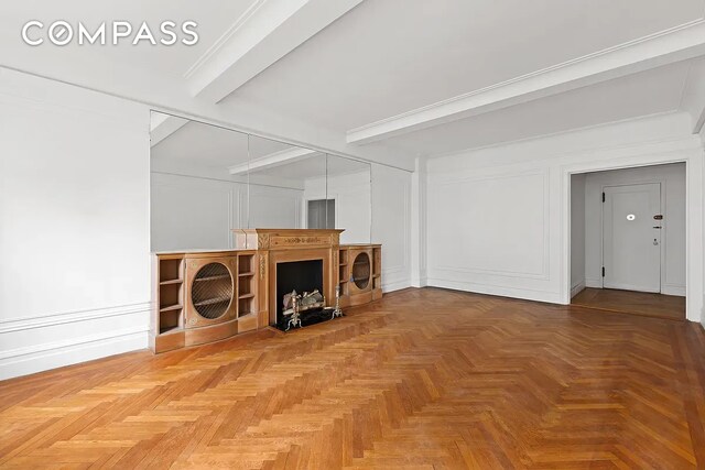 living room with parquet flooring and beam ceiling