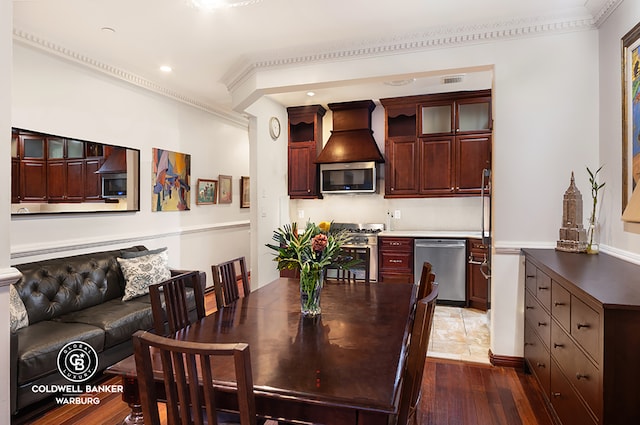 dining room featuring dark hardwood / wood-style flooring and crown molding