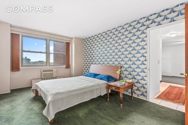 bedroom with an AC wall unit and carpet flooring