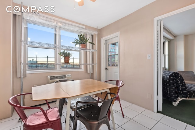 tiled dining space with ceiling fan and a wall unit AC