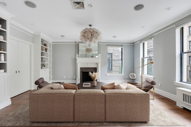 living room with crown molding and wood-type flooring