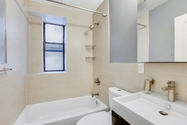 full bathroom featuring tasteful backsplash, sink, toilet, tile walls, and tiled shower / bath