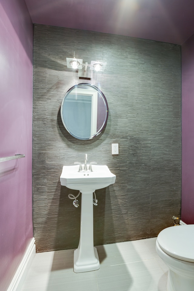 bathroom with toilet and tile patterned floors