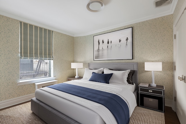 bedroom with hardwood / wood-style flooring and ornamental molding