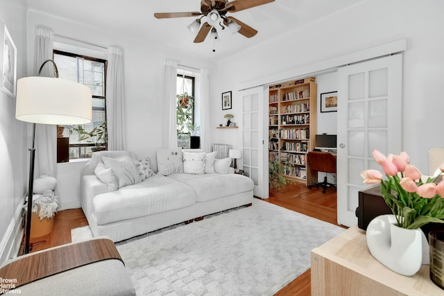 living room with ceiling fan and light hardwood / wood-style floors