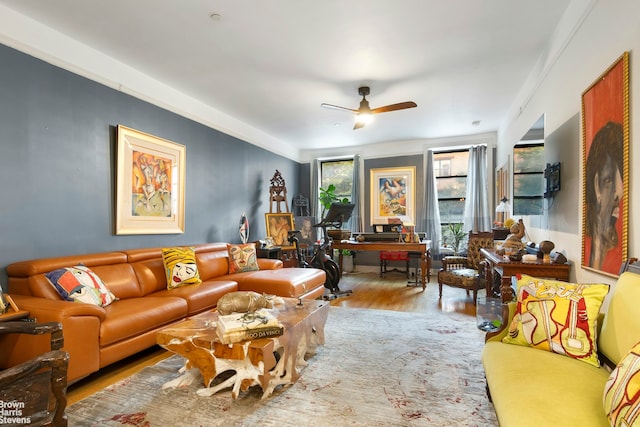 living room with light wood-type flooring and ceiling fan