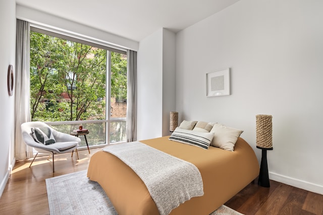 bedroom with dark hardwood / wood-style floors