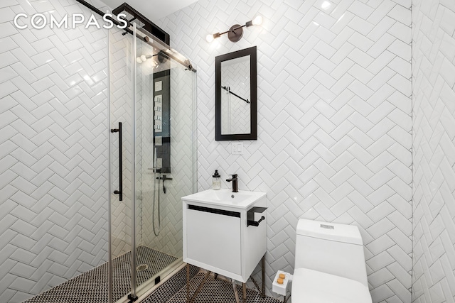 kitchen with stainless steel appliances, sink, light parquet floors, white cabinets, and tasteful backsplash