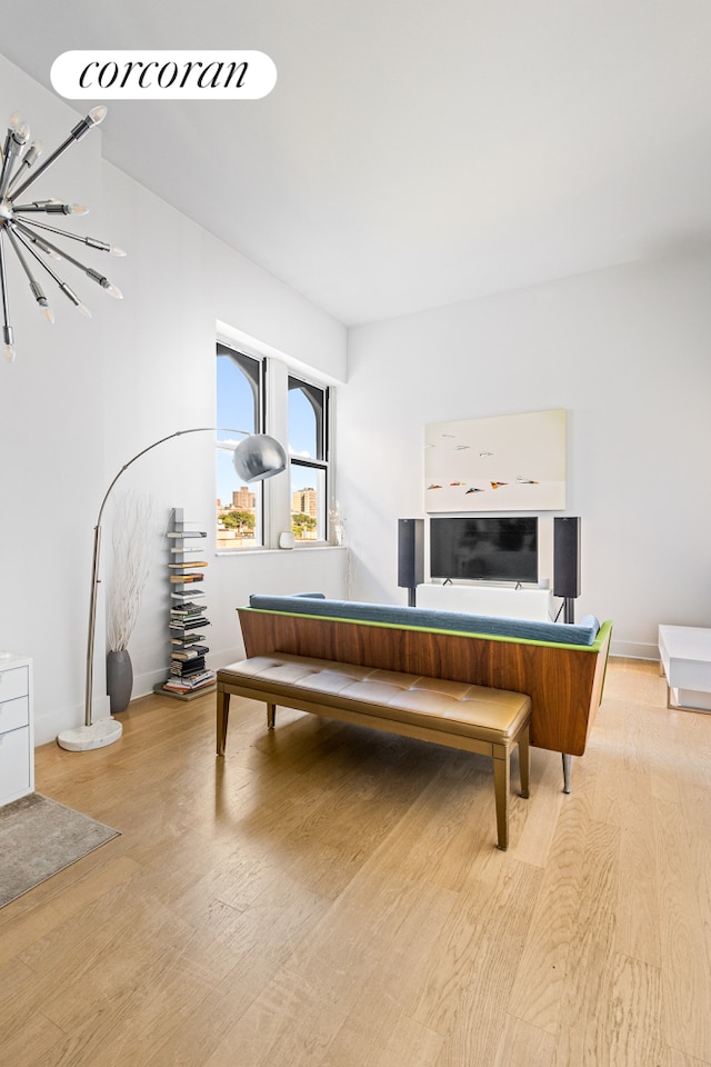 bedroom featuring a notable chandelier and light wood-type flooring