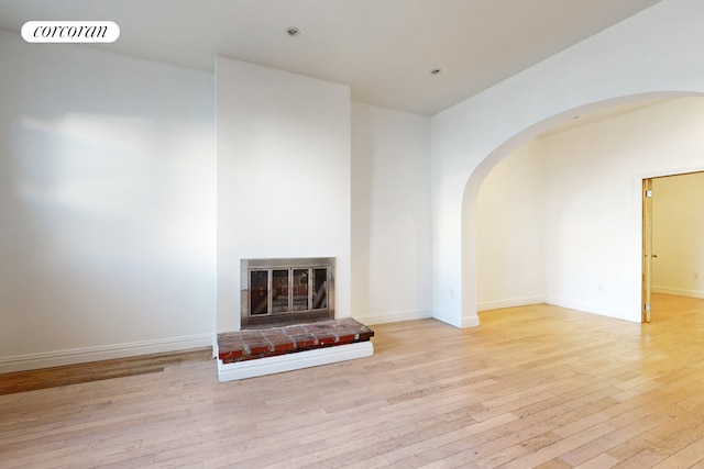 unfurnished living room with light hardwood / wood-style floors and a fireplace