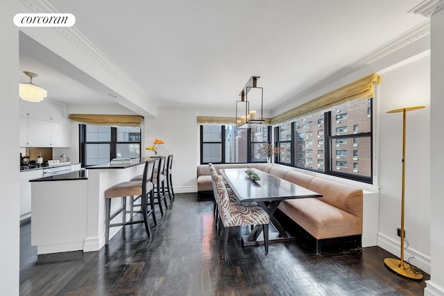 dining area featuring breakfast area, crown molding, a wealth of natural light, and dark hardwood / wood-style floors