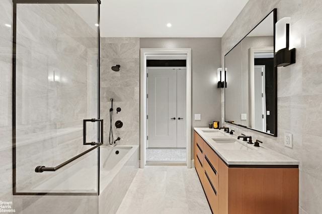 bathroom with tile patterned flooring, vanity, shower with separate bathtub, and tile walls