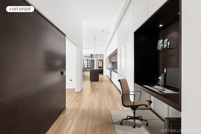 corridor with light hardwood / wood-style floors