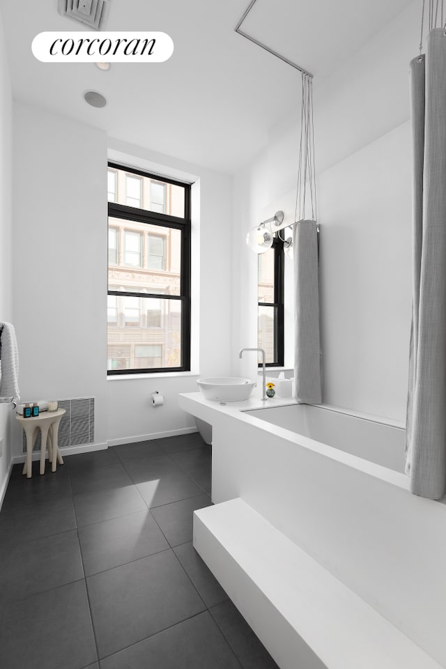 bathroom featuring tile patterned floors and sink