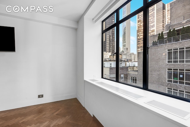 empty room featuring parquet flooring