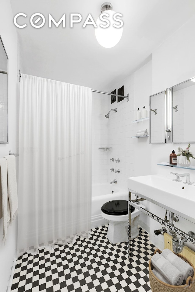 bathroom featuring shower / bath combination with curtain and toilet