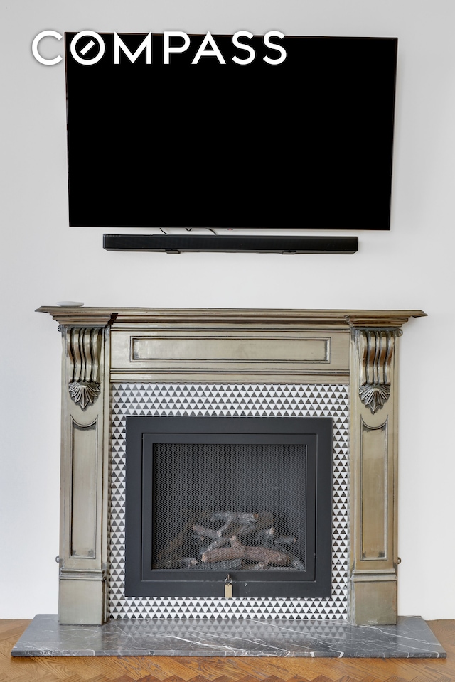 interior details featuring a tiled fireplace