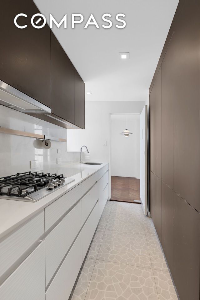 kitchen with sink and stainless steel gas cooktop