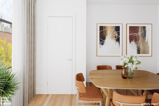 dining space with plenty of natural light and light hardwood / wood-style flooring