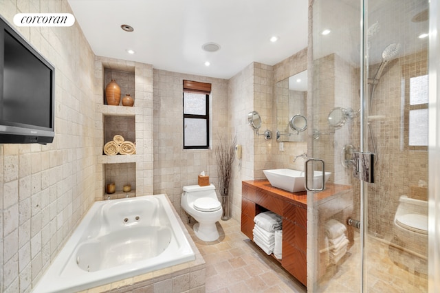 full bathroom featuring tile walls, vanity, separate shower and tub, and toilet