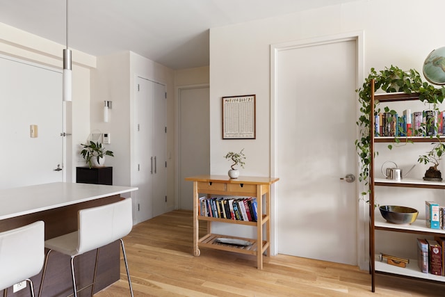 interior space featuring light hardwood / wood-style floors and a kitchen bar