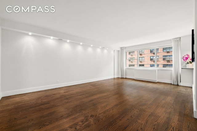 empty room with dark hardwood / wood-style floors