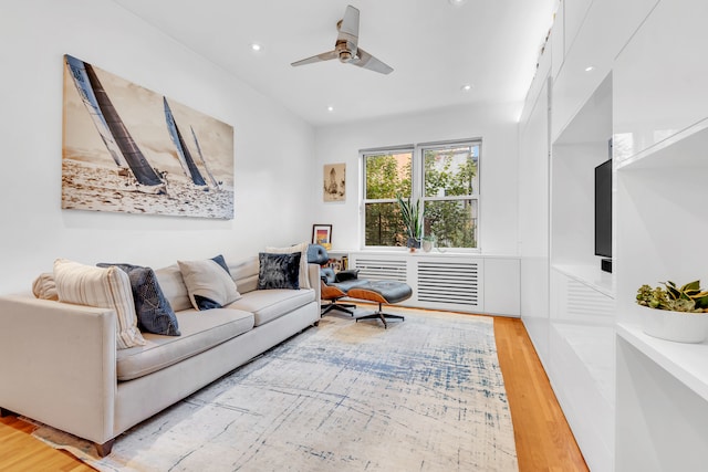 living room featuring ceiling fan and light wood-type flooring