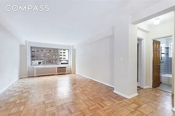 unfurnished living room with light parquet flooring