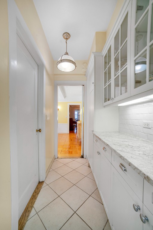 hall featuring light tile patterned floors