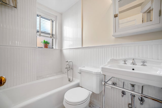 bathroom featuring toilet and a tub