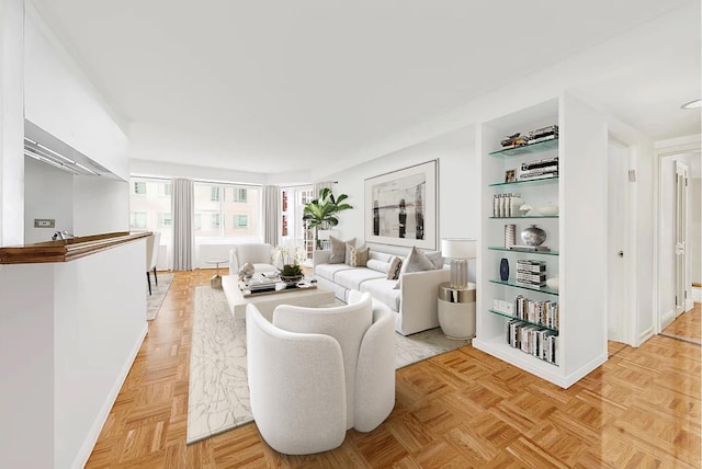 living room with light parquet floors and built in features