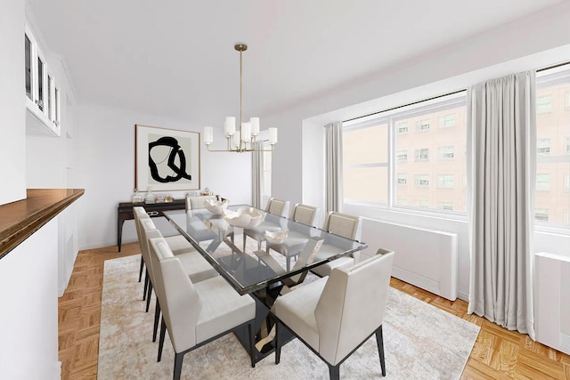 dining room featuring a notable chandelier, light parquet floors, and a healthy amount of sunlight