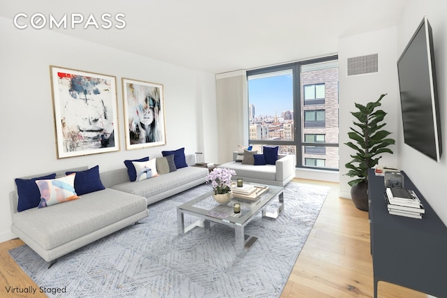 living room featuring expansive windows and wood-type flooring