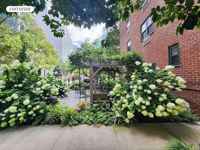 view of community with a pergola and a patio area