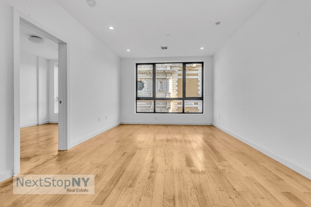 unfurnished room featuring light hardwood / wood-style floors