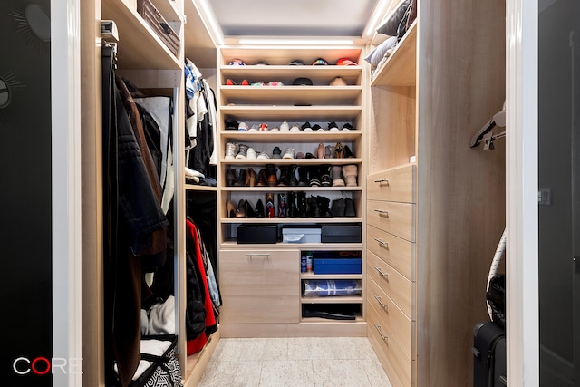 spacious closet featuring light tile patterned floors