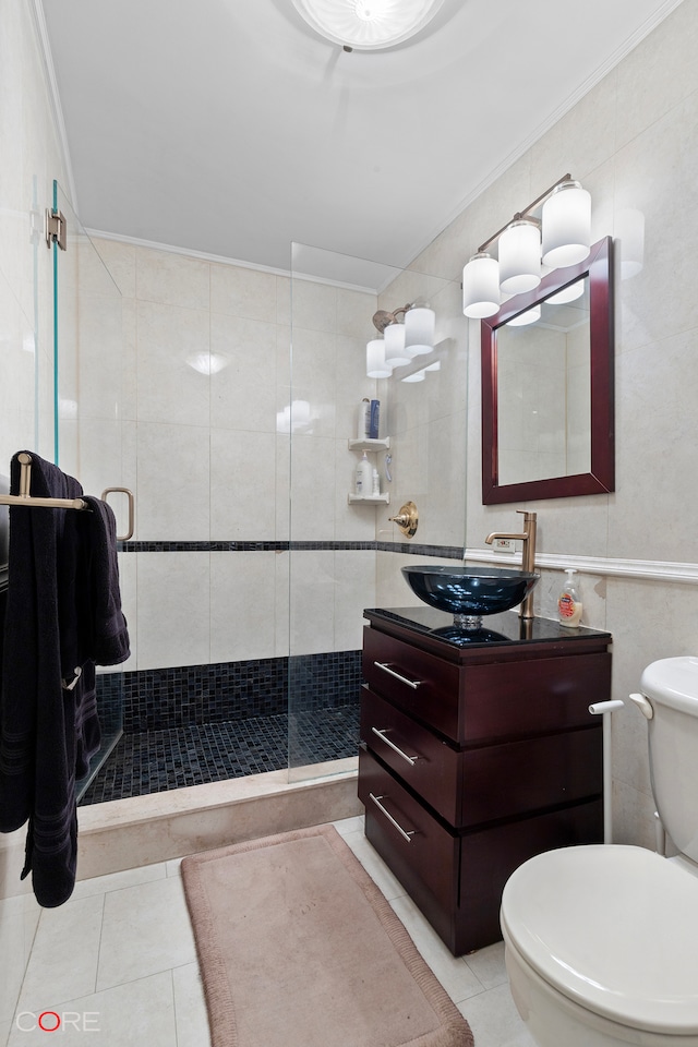 bathroom with vanity, tile walls, toilet, and tile patterned flooring