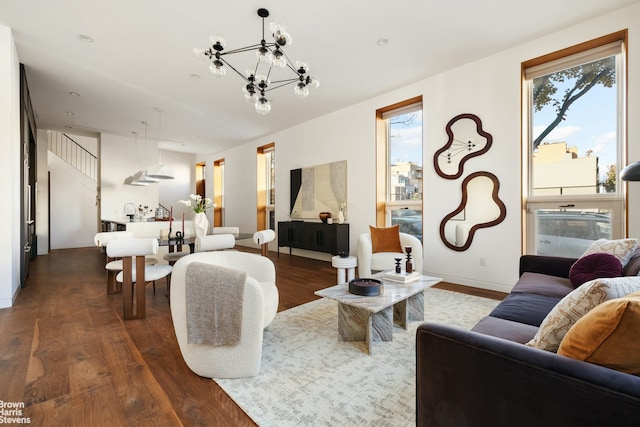 living room featuring a notable chandelier and dark hardwood / wood-style flooring