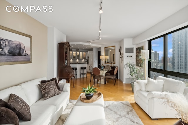 living room featuring track lighting and light hardwood / wood-style floors