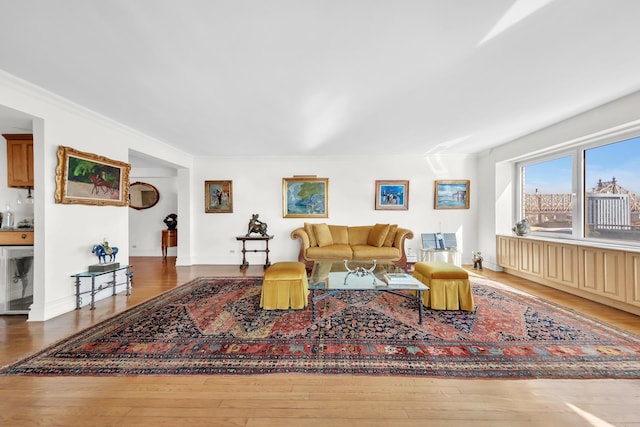 living room with hardwood / wood-style floors and crown molding