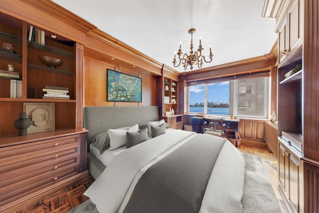 bedroom with a chandelier, crown molding, a water view, and light parquet flooring